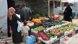 Syrian refugees shop at a makeshift grocery store at the Zaatari camp in March.