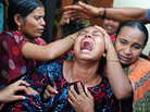 Relatives react after identifying the body of a loved one who was killed in last week's building collapse in Savar, on the outskirts of Dhaka, Bangladesh. Relatives react after identifying the body of a loved one who was killed in last week's building collapse in Savar, on the outskirts of Dhaka, Bangladesh.