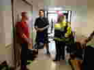 Marine Sgt. Maj. Damion Jacobs (left) and Marine Capt. Cam West visit with Boston emergency workers who responded to the bombings at the Boston Marathon.