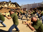 Businessmen from Philadelphia practice with wooden cutouts of rifles at Caliber 3, a counter-terrorism training center amid Israeli settlements south of Jerusalem. Millions of tourists visit Israel each year and for those interested in Israel's security, for a price they can spend a few hours learning commando techniques. Businessmen from Philadelphia practice with wooden cutouts of rifles at Caliber 3, a counter-terrorism training center amid Israeli settlements south of Jerusalem. Millions of tourists visit Israel each year and for those interested in Israel's security, for a price they can spend a few hours learning commando techniques.