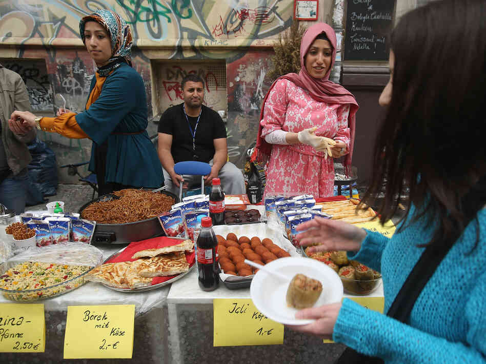 Vendors sell Turkish food in the immigrant-heavy Kreuzberg district in Berlin. A labor deal between Turkey and Germany in 1961 brought a flood of Turks to Germany. Vendors sell Turkish food in the immigrant-heavy Kreuzberg district in Berlin. A labor deal between Turkey and Germany in 1961 brought a flood of Turks to Germany.