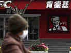 A woman wearing a mask rides past a KFC restaurant in Shanghai last month. Food scares and the bird flu haven't stopped many chicken lovers in the city from visiting KFC and other restaurants. A woman wearing a mask rides past a KFC restaurant in Shanghai last month. Food scares and the bird flu haven't stopped many chicken lovers in the city from visiting KFC and other restaurants.