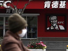 A woman wearing a mask rides past a KFC restaurant in Shanghai last month. Food scares and the bird flu haven't stopped many chicken lovers in the city from visiting KFC and other restaurants. A woman wearing a mask rides past a KFC restaurant in Shanghai last month. Food scares and the bird flu haven't stopped many chicken lovers in the city from visiting KFC and other restaurants.