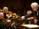 A Detroit Symphony violinist savors a moment in music by Rachmaninov. Leonard Slatkin began the concert with two lesser-known Rachmaninov symphonic poems: The glittering Caprice bohemian and the eerie Isle of the Dead.