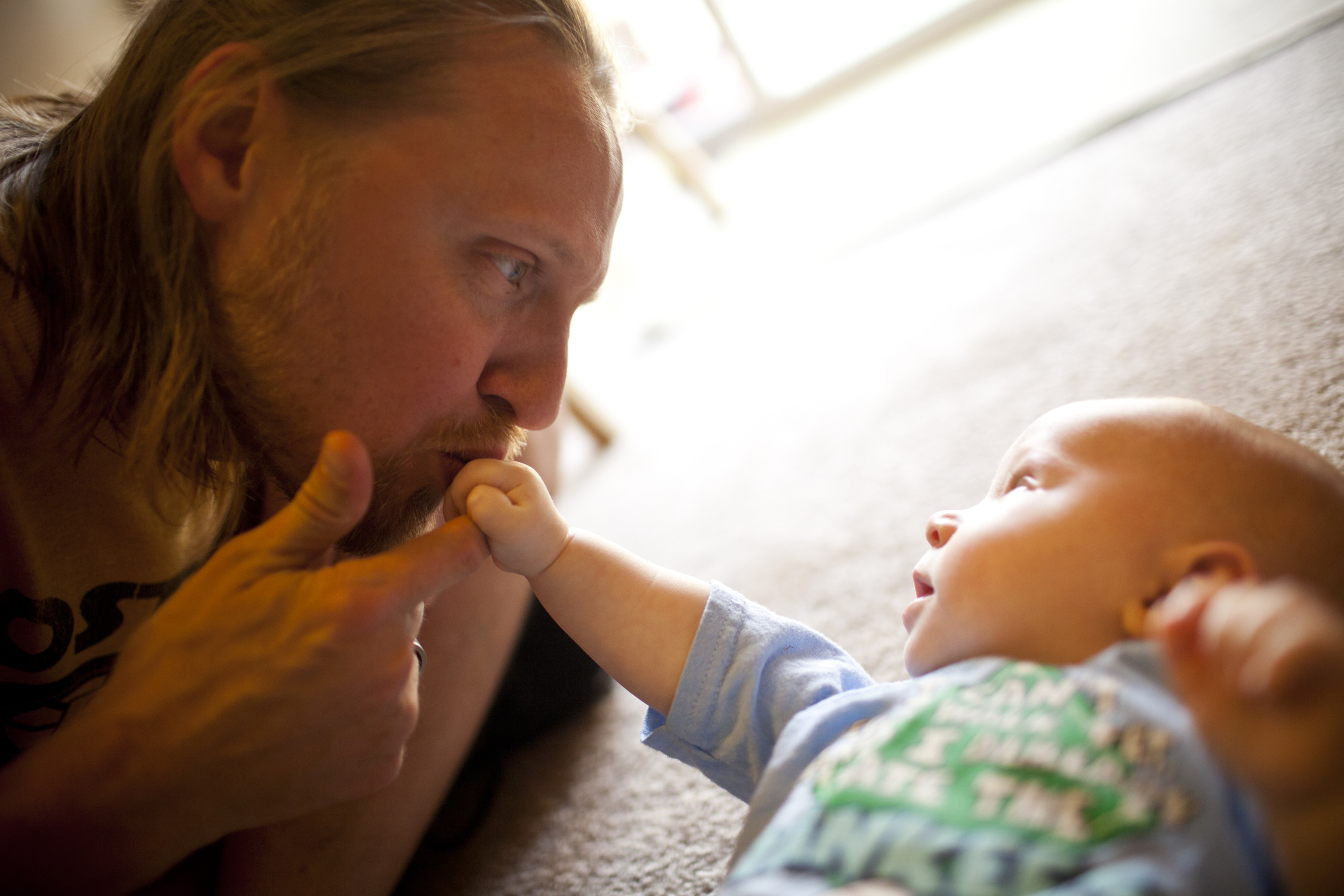 Jonathan Heisey-Grove kisses his 4-month-old son, Zane, in their home in Alexandria, Va. Jonathan is part of a growing number of fathers who stay at home full time while their wives financially support the family.