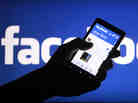 A smartphone user shows the Facebook application on his phone.