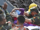 Rescuers carry a survivor who was buried for 17 days under the rubble of a building that collapsed in Saver, near Dhaka, Bangladesh. Rescuers carry a survivor who was buried for 17 days under the rubble of a building that collapsed in Saver, near Dhaka, Bangladesh.