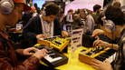 Attendees at the 2012 show of the National Association of Music Merchants. MIDI was first demonstrated at the NAMM show in 1983; today, it's built into most of the gear at the show. Attendees at the 2012 show of the National Association of Music Merchants. MIDI was first demonstrated at the NAMM show in 1983; today, it's built into most of the gear at the show.