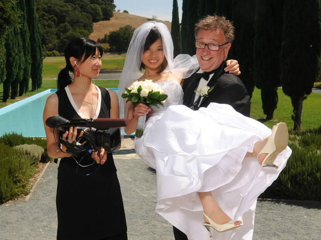 Filmmaker Debbie Lum poses with Steven and Sandy, her documentary subjects, on their wedding day. Filmmaker Debbie Lum poses with Steven and Sandy, her documentary subjects, on their wedding day.