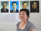 The wife of Li Yiqian, Yang Liming, sits in their house, which is plastered with pictures of China's leaders, an attempt to help prevent local authorities from demolishing it. Her husband has been sentenced to three years in prison for organizing a crowd to create a disturbance; she believes it's for his work in helping dispossessed villagers petition. The wife of Li Yiqian, Yang Liming, sits in their house, which is plastered with pictures of China's leaders, an attempt to help prevent local authorities from demolishing it. Her husband has been sentenced to three years in prison for organizing a crowd to create a disturbance; she believes it's for his work in helping dispossessed villagers petition.