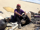 Abimael Martinez, who was deported from Riverside, Calif., sits next to the hole he dug to live in beneath the banks of Tijuana's fetid river canal. Abimael Martinez, who was deported from Riverside, Calif., sits next to the hole he dug to live in beneath the banks of Tijuana's fetid river canal.