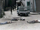 This image provided by the Syrian Revolution against Bashar Assad and released May 2 shows soldiers loyal to Syrian President Bashar Assad standing amid dead bodies at Bayda village, in the mountains outside the coastal city of Banias, Syria. This image provided by the Syrian Revolution against Bashar Assad and released May 2 shows soldiers loyal to Syrian President Bashar Assad standing amid dead bodies at Bayda village, in the mountains outside the coastal city of Banias, Syria.