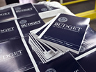 Copies of President Obama's budget plan for fiscal 2014 are prepared for delivery at the U.S. Government Printing Office in Washington in April. The Congressional Budget Office has sharply cut the outlook for the federal deficit. Copies of President Obama's budget plan for fiscal 2014 are prepared for delivery at the U.S. Government Printing Office in Washington in April. The Congressional Budget Office has sharply cut the outlook for the federal deficit.