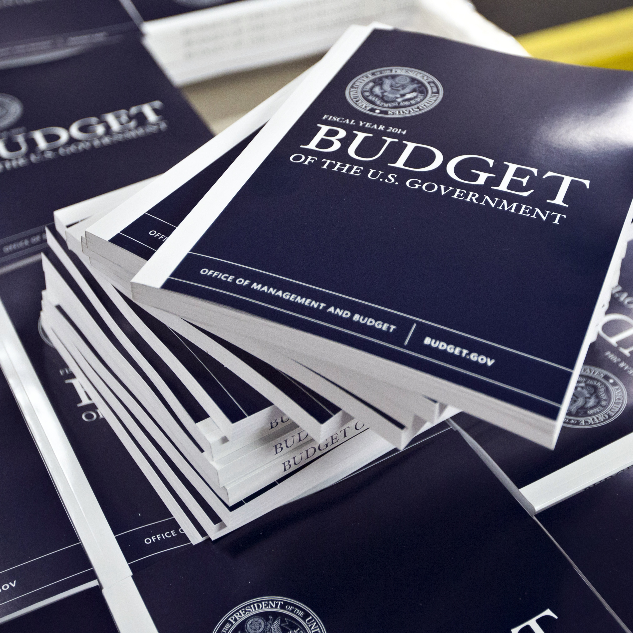 Copies of President Obama's budget plan for fiscal 2014 are prepared for delivery at the U.S. Government Printing Office in Washington in April. The Congressional Budget Office has sharply cut the outlook for the federal  deficit.