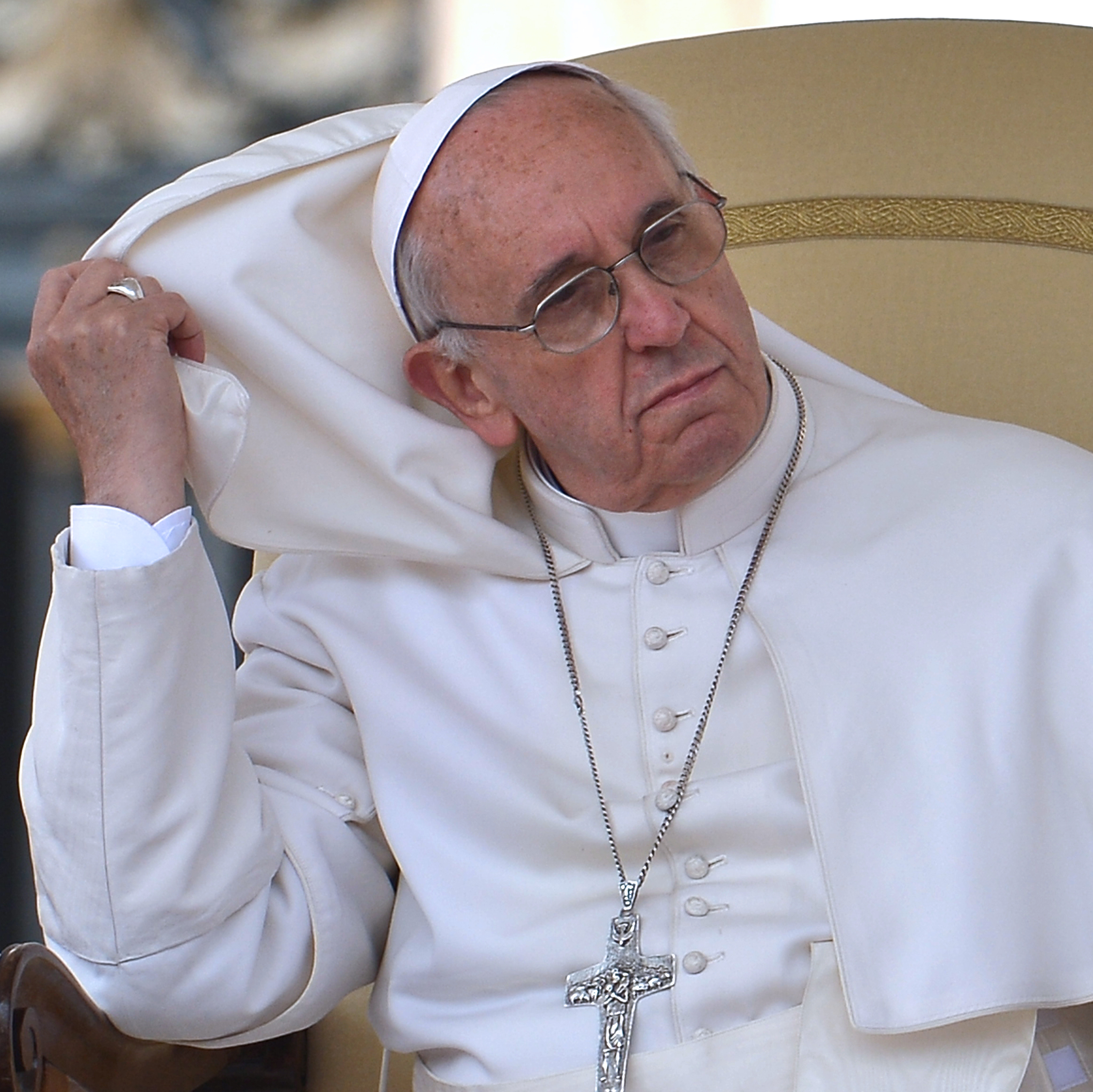 Pope Francis adjusts his pellegrina during his weekly general audience in St Peter's Square at the Vatican on Wednesday.