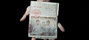 Sonny Vaahn, 25, holds his family's refugee identification in Bronx, N.Y. The card was issued to them during their initial entry into a refugee camp along the Thai-Cambodian border after the "killing fields" atrocities ended in Cambodia.