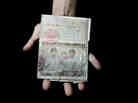 Sonny Vaahn, 25, holds his family's refugee identification in Bronx, N.Y. The card was issued to them during their initial entry into a refugee camp along the Thai-Cambodian border after the "killing fields" atrocities ended in Cambodia.