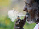 A man smokes a cigarette as he takes a break at a fruit market in Hyderabad, India. Smoking tobacco is eight times more prevalent among Indian men than women. A man smokes a cigarette as he takes a break at a fruit market in Hyderabad, India. Smoking tobacco is eight times more prevalent among Indian men than women.