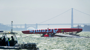 The Artemis Racing AC72 catamaran lies capsized after a training sail in San Francisco Bay on May 9.