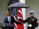 President Obama checks to see if it's still raining as a Marine holds an umbrella for him during a joint news conference with Turkish Prime Minister Recep Tayyip Erdogan at the White House on Thursday. President Obama checks to see if it's still raining as a Marine holds an umbrella for him during a joint news conference with Turkish Prime Minister Recep Tayyip Erdogan at the White House on Thursday.