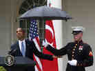 President Obama checks to see if it's still raining as a Marine holds an umbrella for him during a joint news conference with Turkish Prime Minister Recep Tayyip Erdogan at the White House on Thursday.