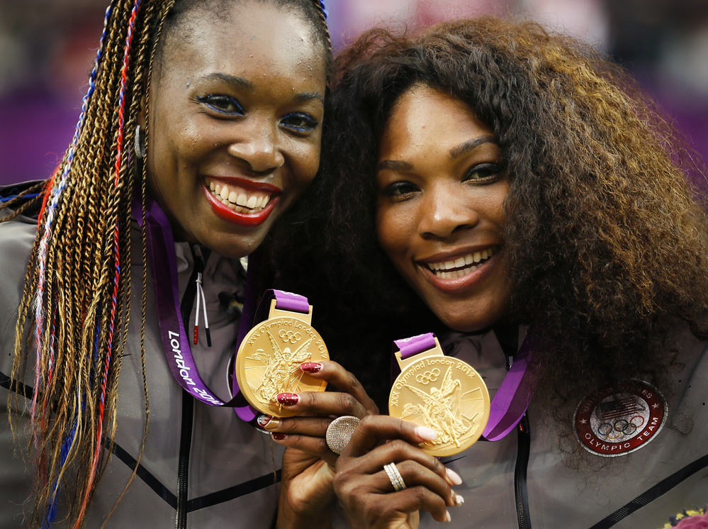 Serena (right) and Venus Williams pose with their gold medals during the London 2012 Olympic Games.
