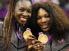Serena (right) and Venus Williams pose with their gold medals during the London 2012 Olympic Games. Serena (right) and Venus Williams pose with their gold medals during the London 2012 Olympic Games.