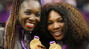Serena (right) and Venus Williams pose with their gold medals during the London 2012 Olympic Games.