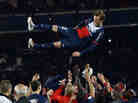 Paris Saint-Germain's English midfielder David Beckham is thrown in the air by teammates after a French L1 football match between Paris St Germain and Brest on Saturday at Parc des Princes stadium in Paris.