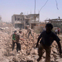 Syrians inspect Saturday the rubble of buildings damaged by government airstrikes in Qusair, Syria. The image was provided by Qusair Lens, and was authenticated based on its contents and other AP reporting. Syrians inspect Saturday the rubble of buildings damaged by government airstrikes in Qusair, Syria. The image was provided by Qusair Lens, and was authenticated based on its contents and other AP reporting.