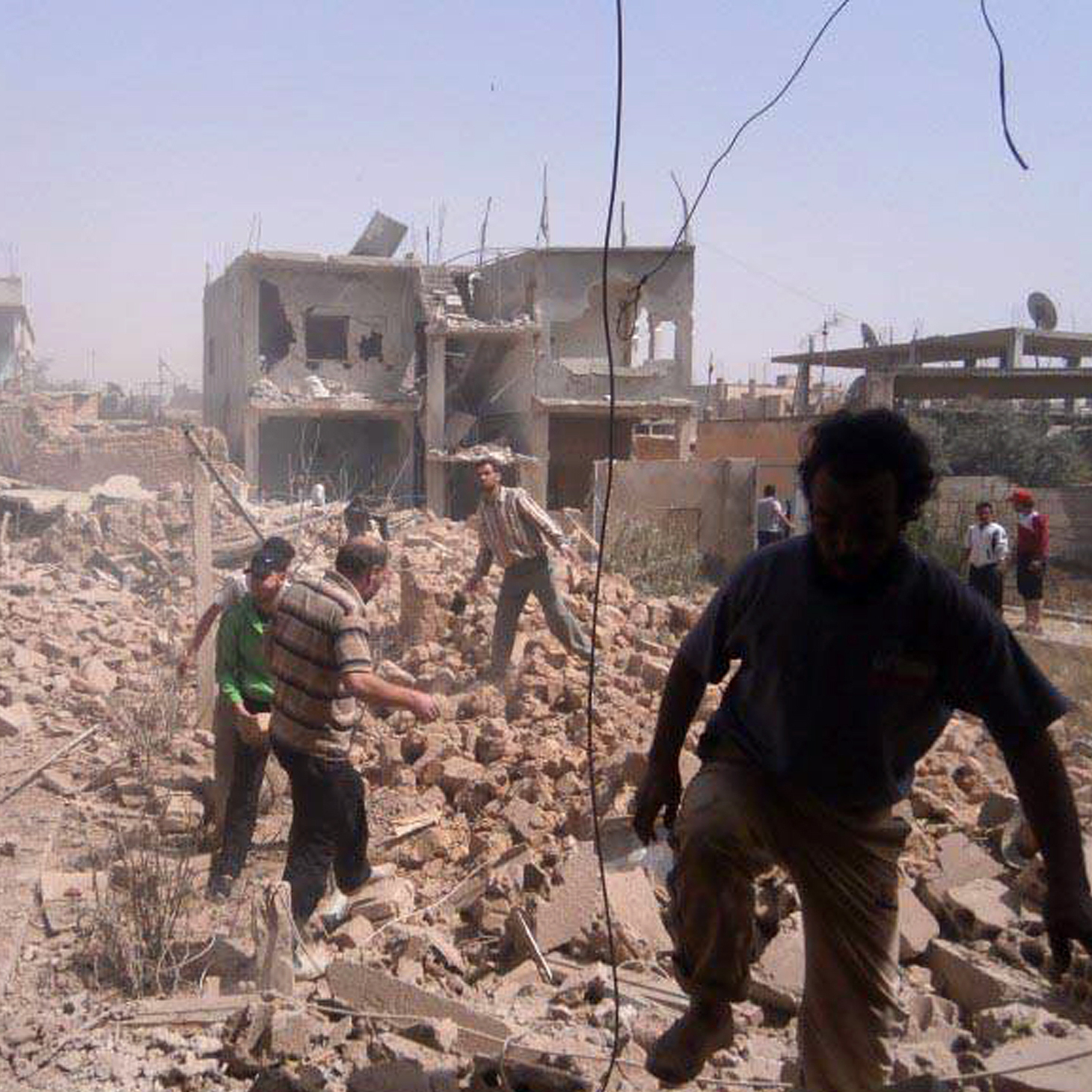 Syrians inspect Saturday the rubble of buildings damaged by government airstrikes in Qusair, Syria. The image was provided by Qusair Lens, and was authenticated based on its contents and other AP reporting.