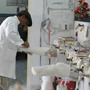 A technician shapes a cast mold for a prosthetic limb at the Red Cross orthopedic clinic in Kabul. The clinic produces about 2,000 prosthetic limbs each year.