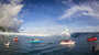 Boats line up to photograph this year's Teahupoo swell in Tahiti.