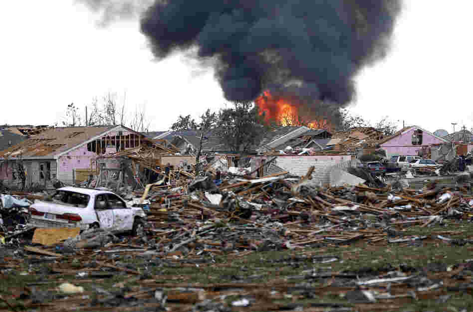 A fire burns in Moore after the twister, which had a rating of at least EF-4, according to the National Weather Service.