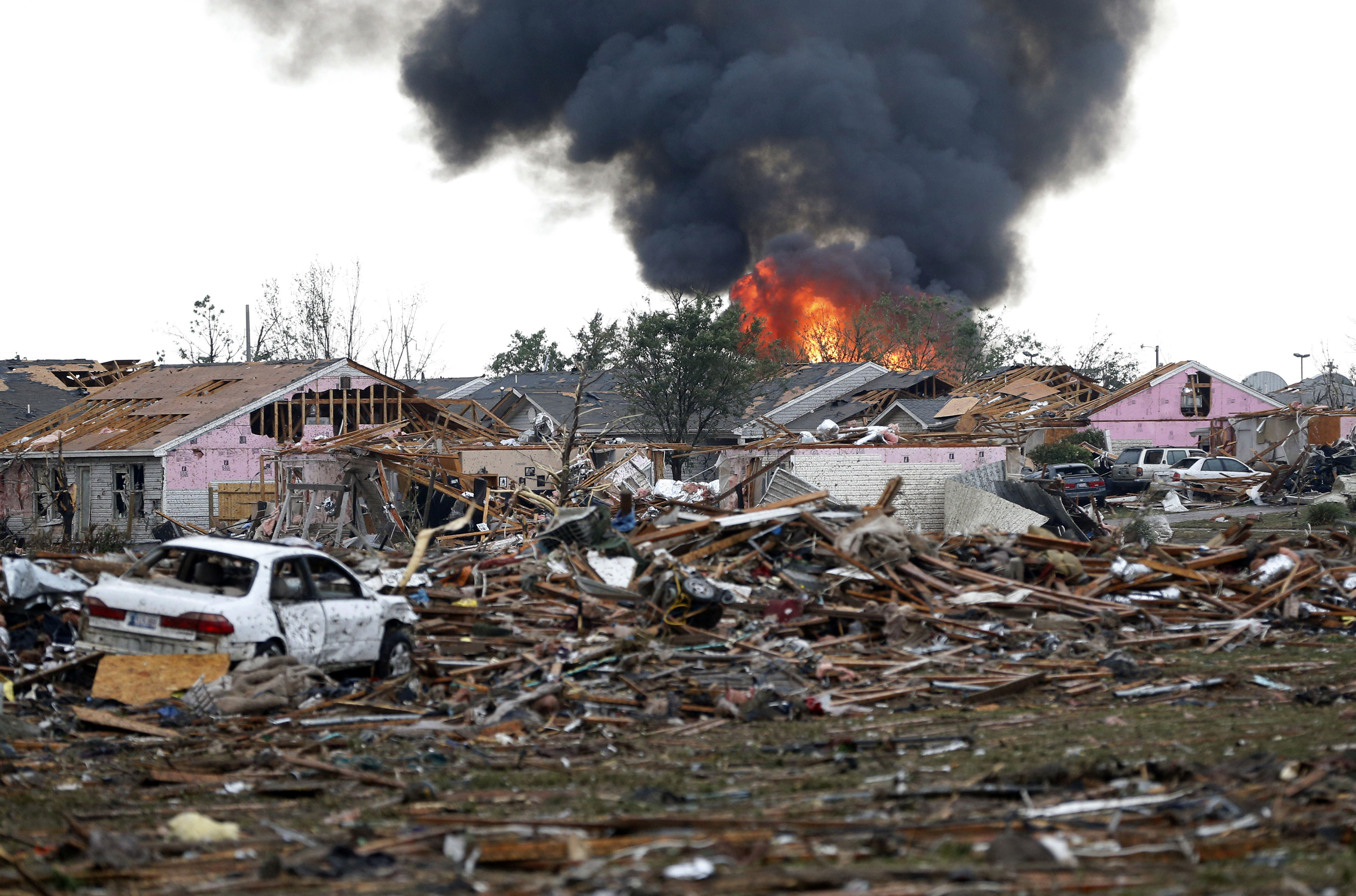 A fire burns in Moore after the twister, which had a rating of at least EF-4, according to the National Weather Service.