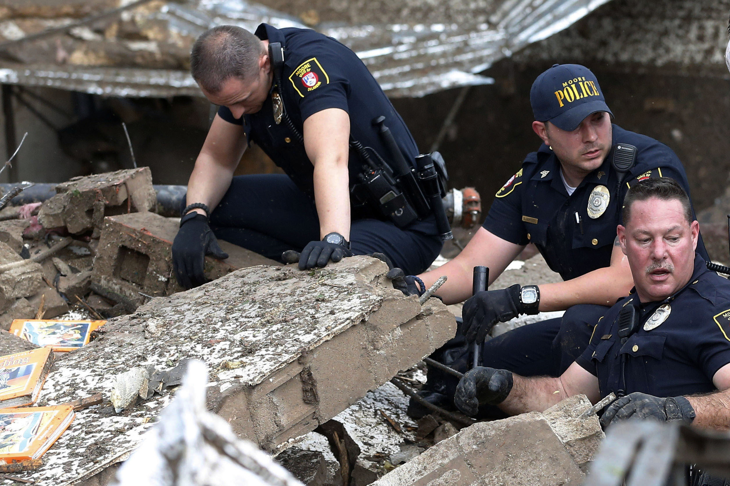 Moore police dig through the rubble of the Plaza Towers Elementary School.