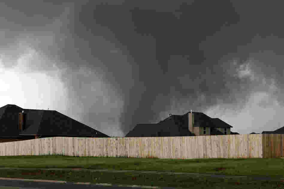 A tornado moves past homes in Moore, Okla. on Monday.