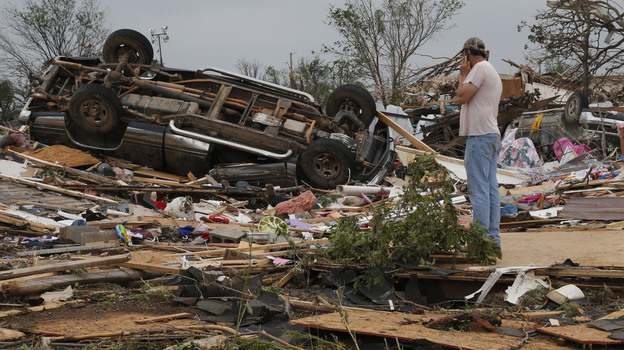 John Warner surveys the damage near a friend's mobile home in the Steelman Estates Mobile Home Park, destroyed in Sunday's tornado, near Shawnee, Okla., on Monday. (AP)