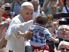 Pope Francis blesses a child Sunday after the Holy Mass at St. Peter's Square, at the Vatican. Pope Francis blesses a child Sunday after the Holy Mass at St. Peter's Square, at the Vatican.