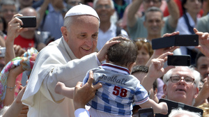 Pope Francis blesses a child Sunday after the Holy Mass at St. Peter's Square, at the Vatican.