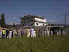Pakistanis, along with international and local media, gather outside Osama bin Laden's compound, a day after the successful raid by U.S. Special Forces in May 2011. Pakistanis, along with international and local media, gather outside Osama bin Laden's compound, a day after the successful raid by U.S. Special Forces in May 2011.