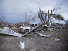 Piles of debris and cars lie around a home destroyed by a tornado in Moore, Oklahoma. Piles of debris and cars lie around a home destroyed by a tornado in Moore, Oklahoma.