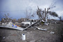 Piles of debris and cars lie around a home destroyed by a tornado in Moore, Oklahoma.