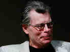 Stephen King holds a special pink Kindle given to him at a 2009 unveiling event for the Amazon Kindle 2.