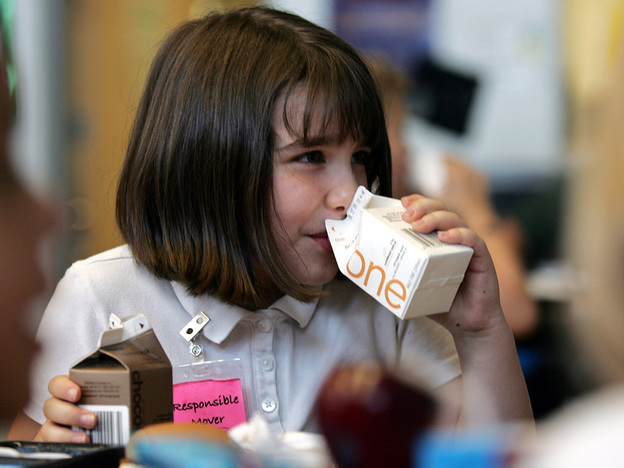 Morgan Barnett, 7, drinks from containers of 1 percent milk and chocolate milk during lunch at a school in St. Paul, Minn., in 2006.