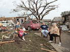 Barbara Garcia, right, sits with friends after a tornado destroyed much of their neighborhood in Moore, Okla. During an interview with CBS, Garcia found her dog buried in the wreckage of her house. Barbara Garcia, right, sits with friends after a tornado destroyed much of their neighborhood in Moore, Okla. During an interview with CBS, Garcia found her dog buried in the wreckage of her house.