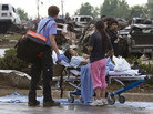 A Moore Medical Center patient sits in the parking lot after a tornado damaged the hospital on Monday. A Moore Medical Center patient sits in the parking lot after a tornado damaged the hospital on Monday.