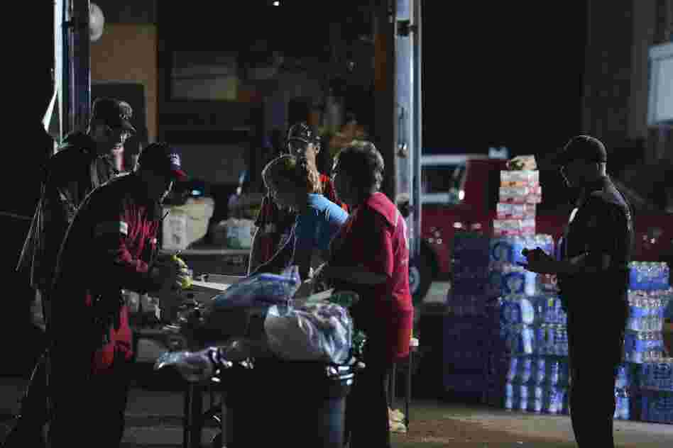Members of the American Red Cross distribute food at a command center the day after a tornado hit in Moore. The storm, estimated to contain winds up to 200-mph. A previous storm in 1999 in Moore caused similar damage and loss of life. 