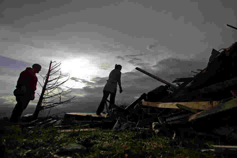 Zac and Denisha Woodcock look through the rubble of their tornado-ravaged home on Tuesday in Moore, Okla. A huge tornado roared through the Oklahoma City suburb Monday, flattening entire neighborhoods and an elementary school.