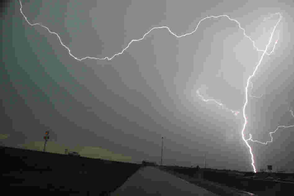 Lightning strikes over interstate 35 near Moore on Tuesday. Thunderstorms and lightning slowed the rescue effort on Tuesday, but more than 100 people had been pulled from the debris alive.